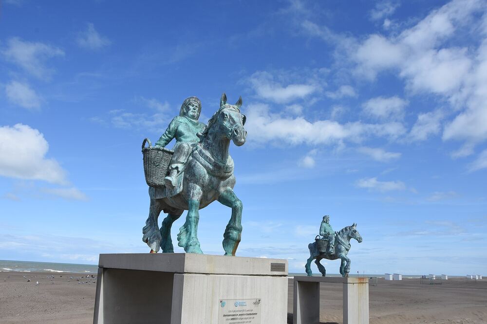 Het bronzen beeld van een paardenvisser te paard op het strand van Oostduinkerke